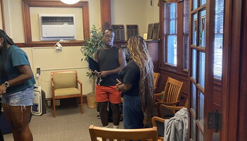 Student and postdoctoral staff member talking