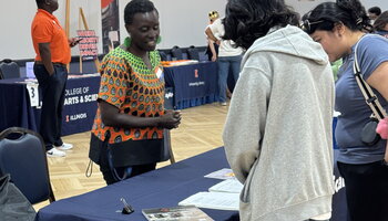 Professor Esther Ngumbi speaking with patrons of the table