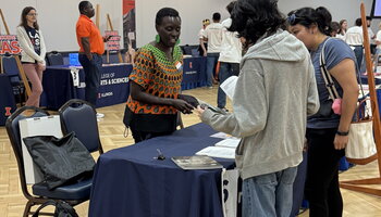 Professor Esther Ngumbi speaking with patrons of the table