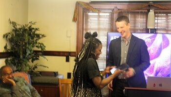 Certificate presented by Professor John Meyers to graduate student Calandra Warren
