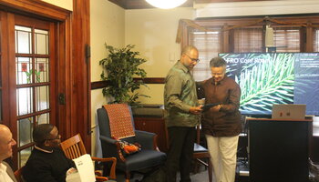 Professor Erik McDuffie accepting his award certificate from Professor Merle Bowen