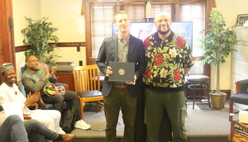 Certificate presented by Professor Eddie O'Byrn to Professor John Meyers