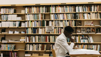 Male student studying in a library