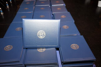 Graduation diplomas on table