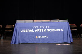 College of LAS table on graduation stage