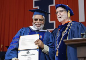 Dr. Lonnie Bunch III receives his honorary degree from President Timothy Killeen