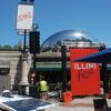 Chicago Cloud Gate sculpture (AKA The Bean) with Illini Fest event signs in the foreground